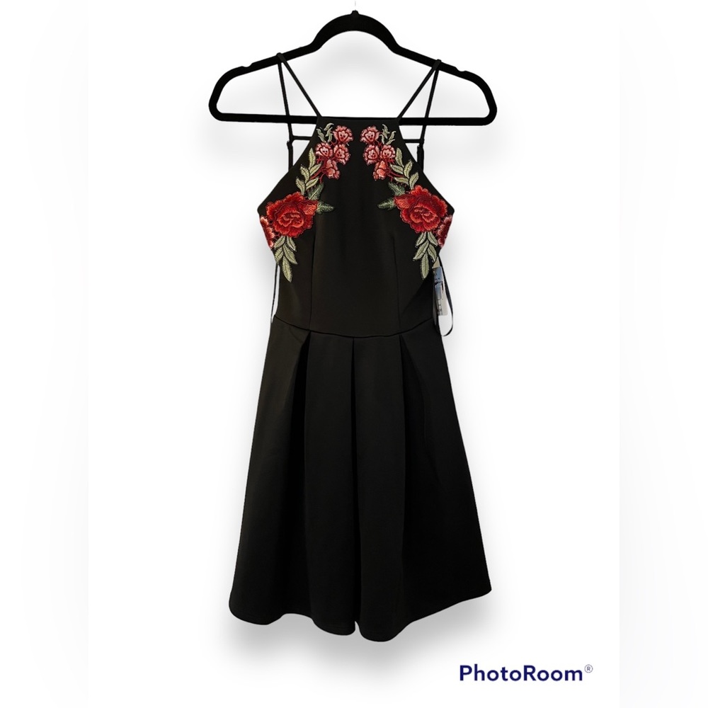 Never worn dress from Belk. Beautiful flower on the bust. Adjustable back straps
